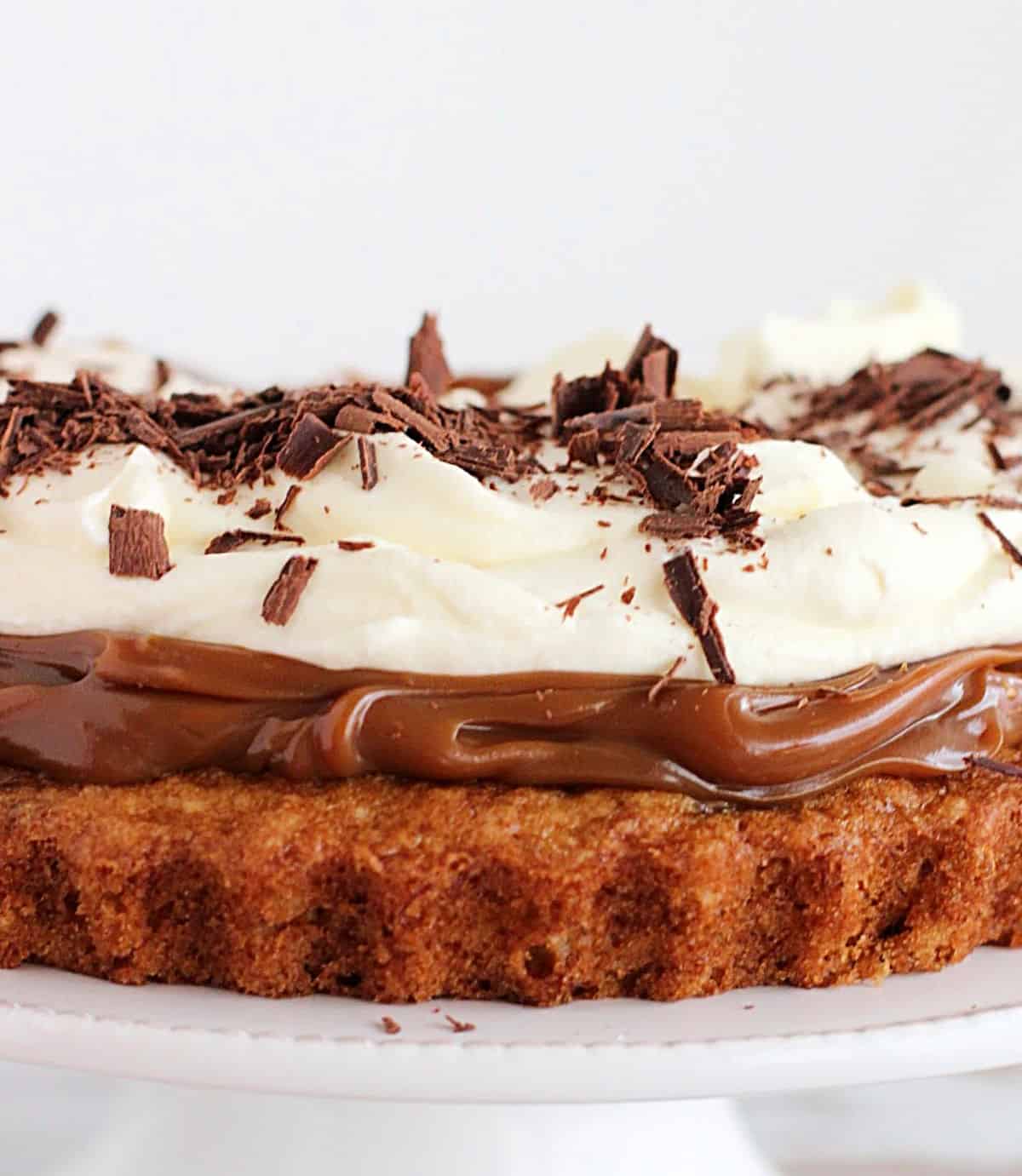 Middle section of banoffee cake photographed with white background