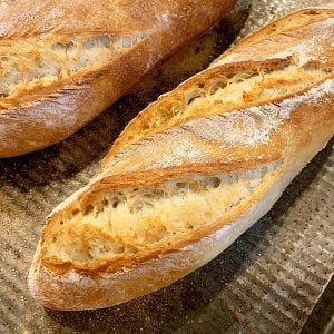 Close up of golden French bread on metal sheet pan