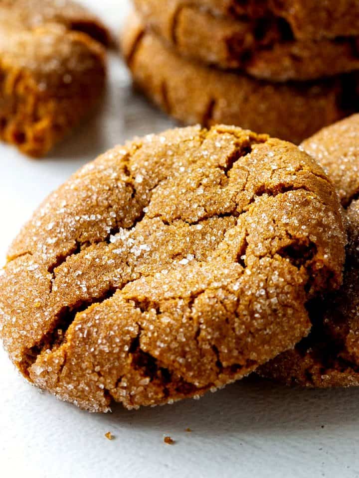 Close up of gingersnap crackled cookies on white surface