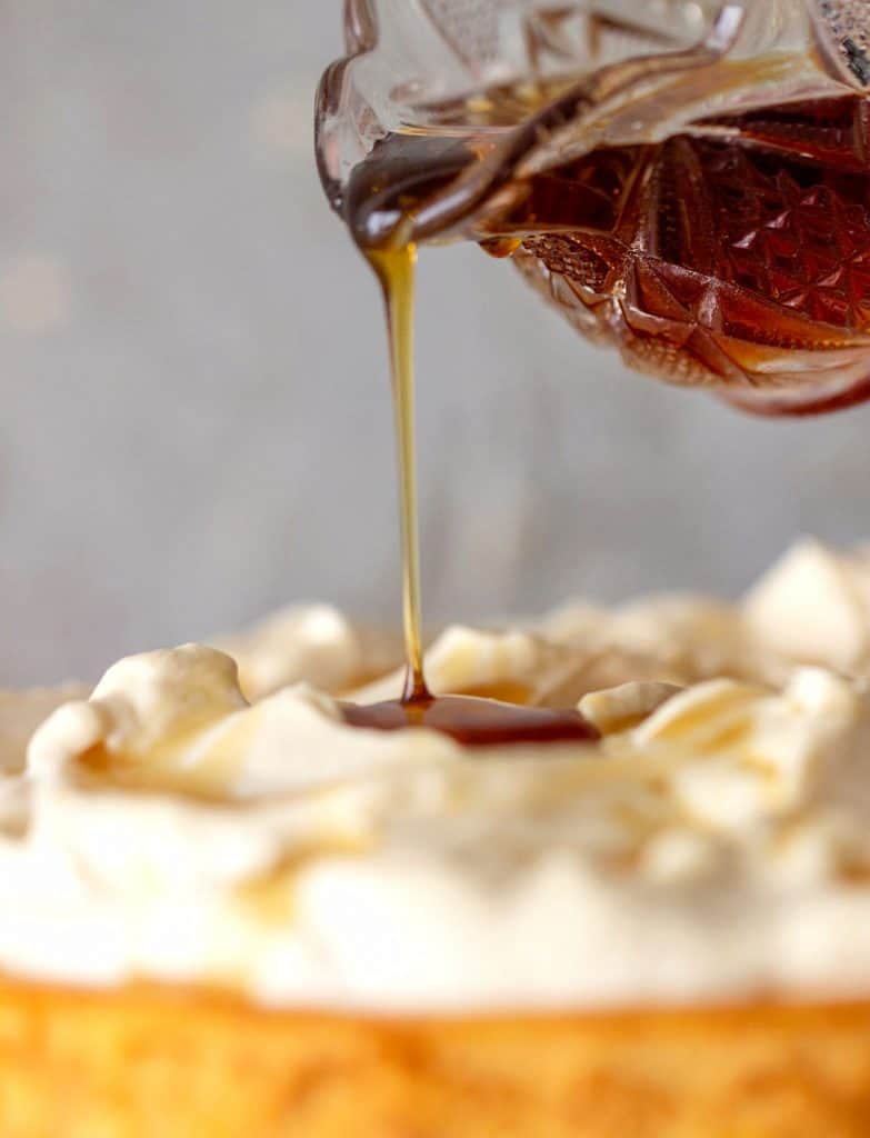 Pouring maple syrup on whipped cream