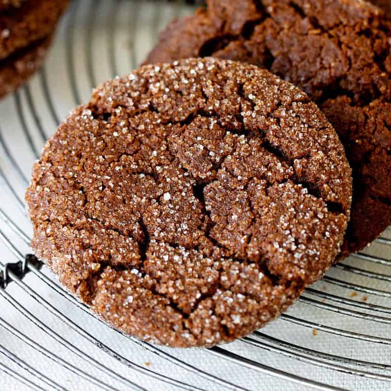 Close up of crackled ginger molasses cookie on wire rack
