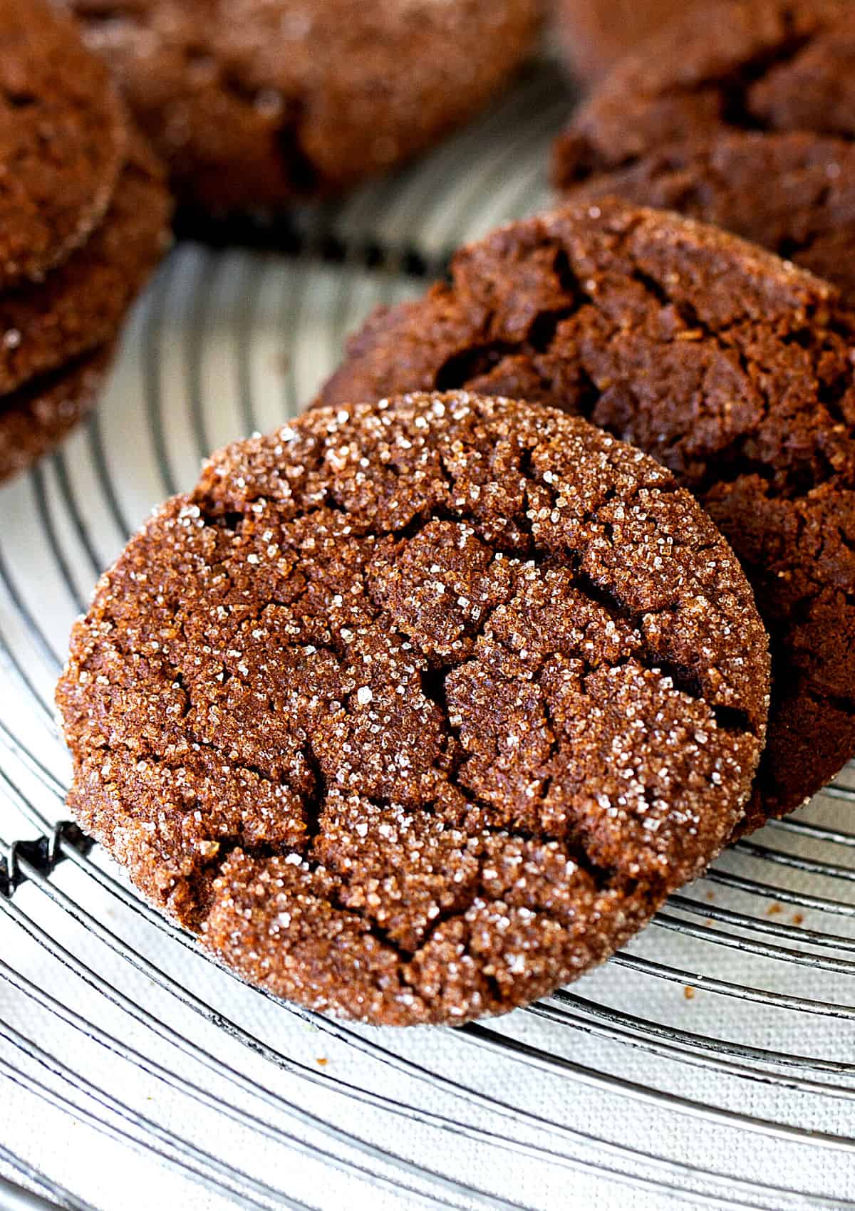 Crackled ginger molasses cookies on a wire rack. Close up image. 