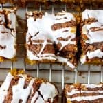Top view of glazed cake squares on metal rack; brown and white text overlay