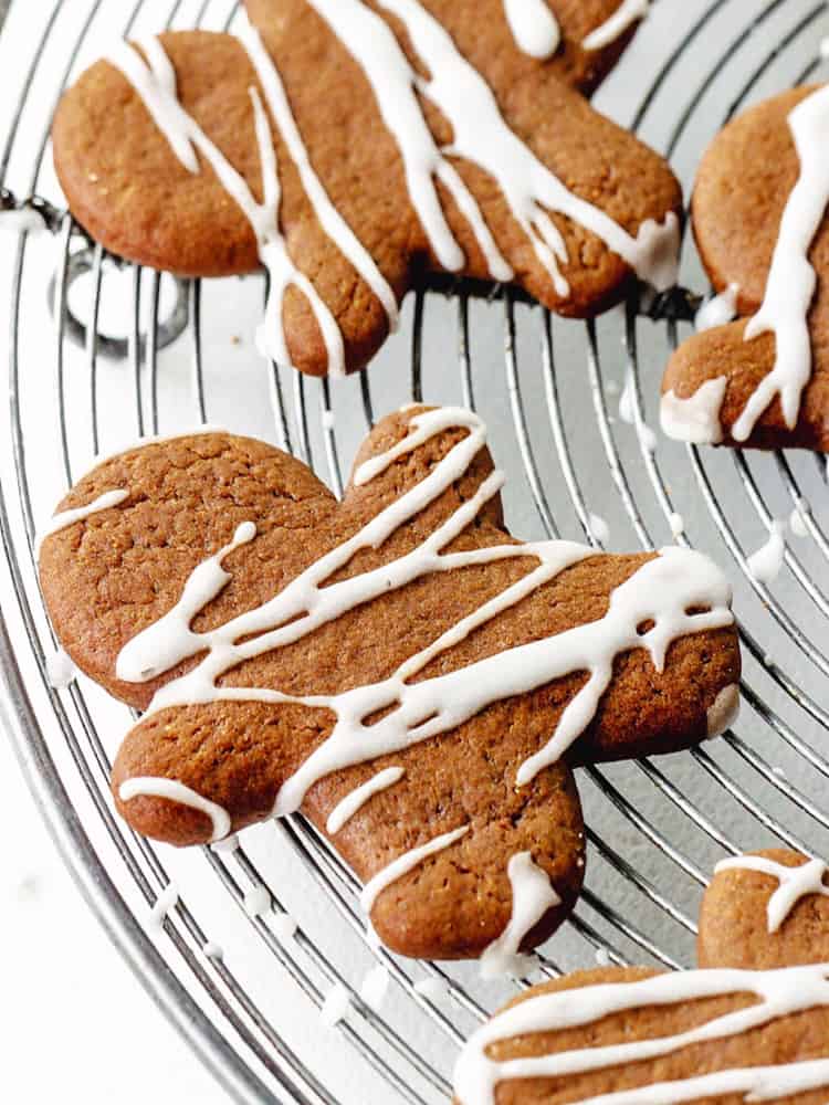 Partial view of a round wire rack with iced gingerbread people on it.