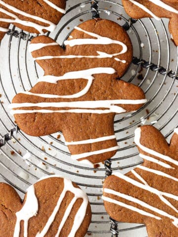 Close up aerial view of iced gingerbread people on a metal wire rack.