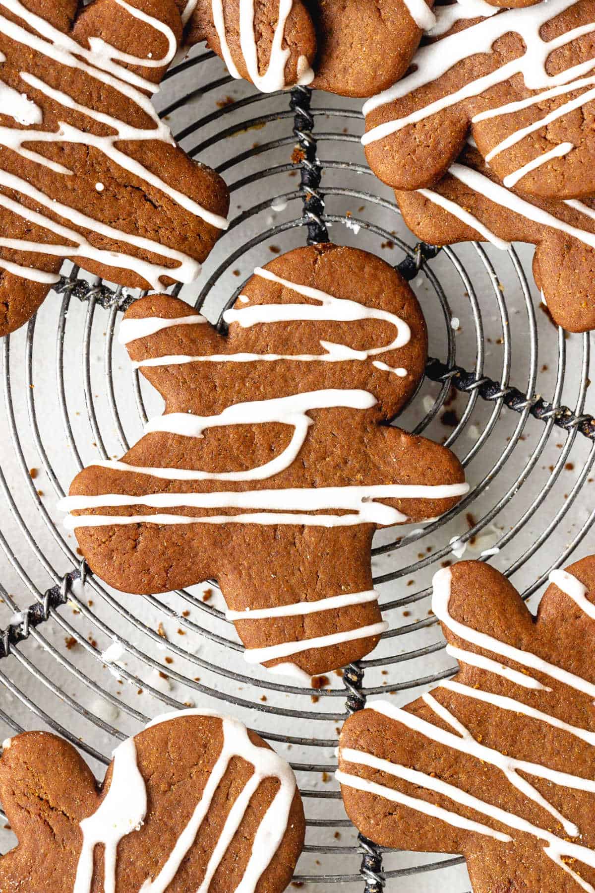 Top view of iced gingerbread cut out people on a wire rack.