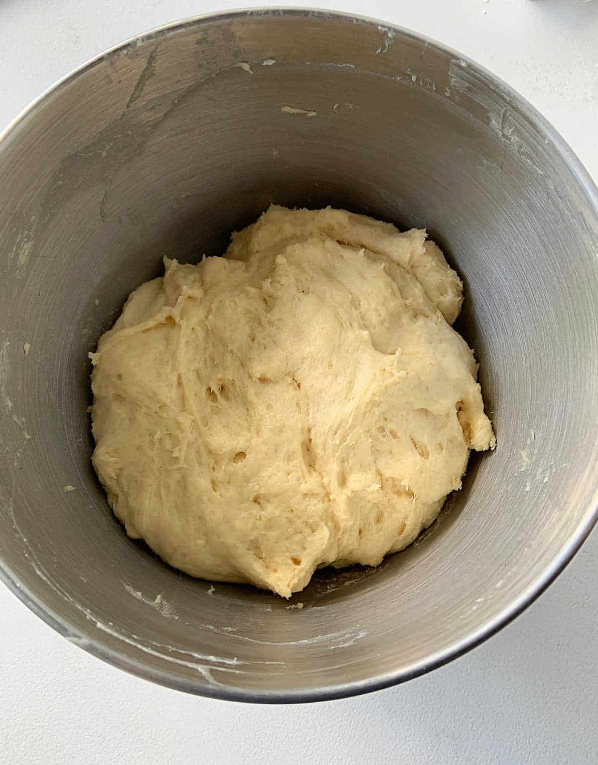 Pandoro dough inside a metal bowl