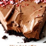 Creamy slice of chocolate mousse tart on white surface; brown and green text