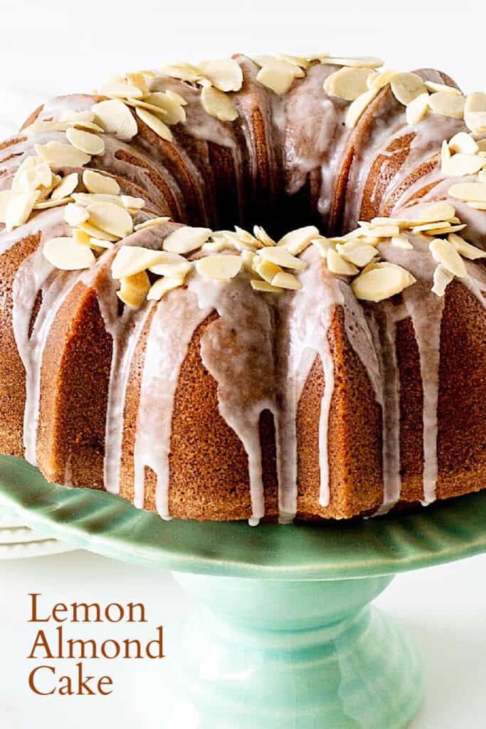 Close up view of glazed bundt cake with almond on green cake stand; brown text