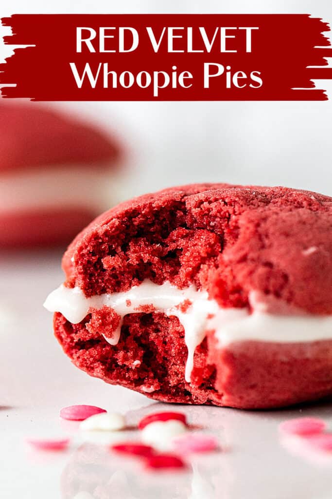 Close up of eaten red velvet whoopie pie on white marble, confetti around, red white text overlay