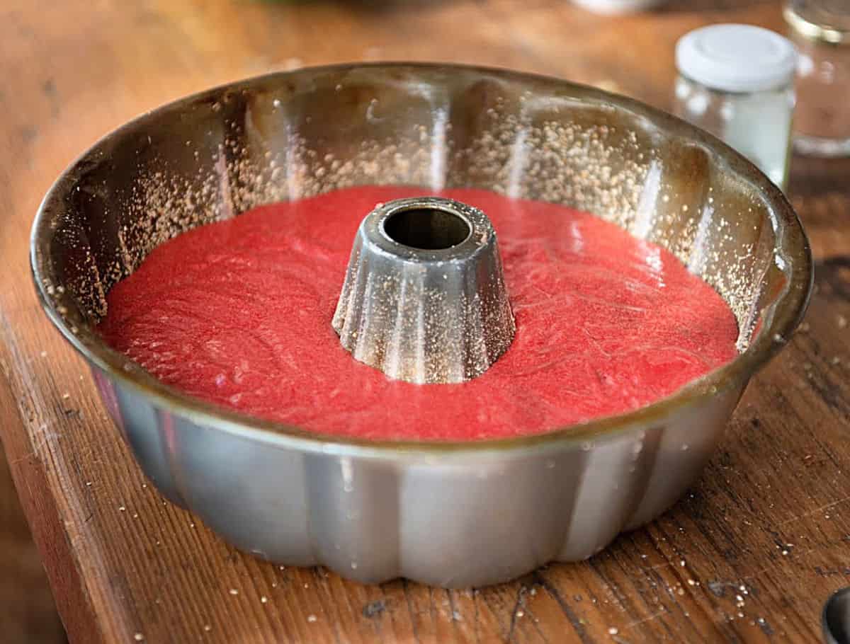 Red cake batter in metal bundt pan