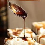 Spoon dripping stout syrup onto squares of cream topped chocolate cake; brown white text overlay