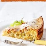 Slice of grape cake in white plate with fork, white background, brown overlay text