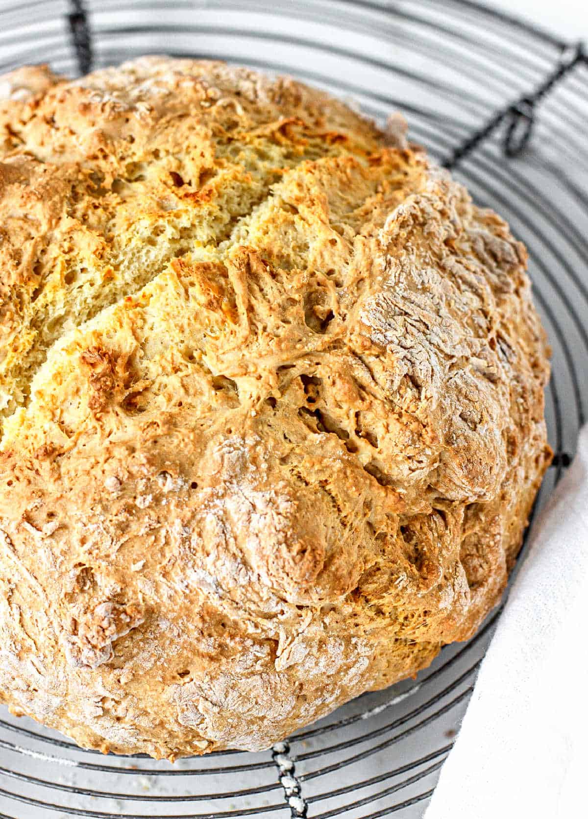 Top view of whole soda bread on round wire rack