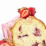 Front view of cut strawberry pound cake with pink glaze, white background, red text overlay