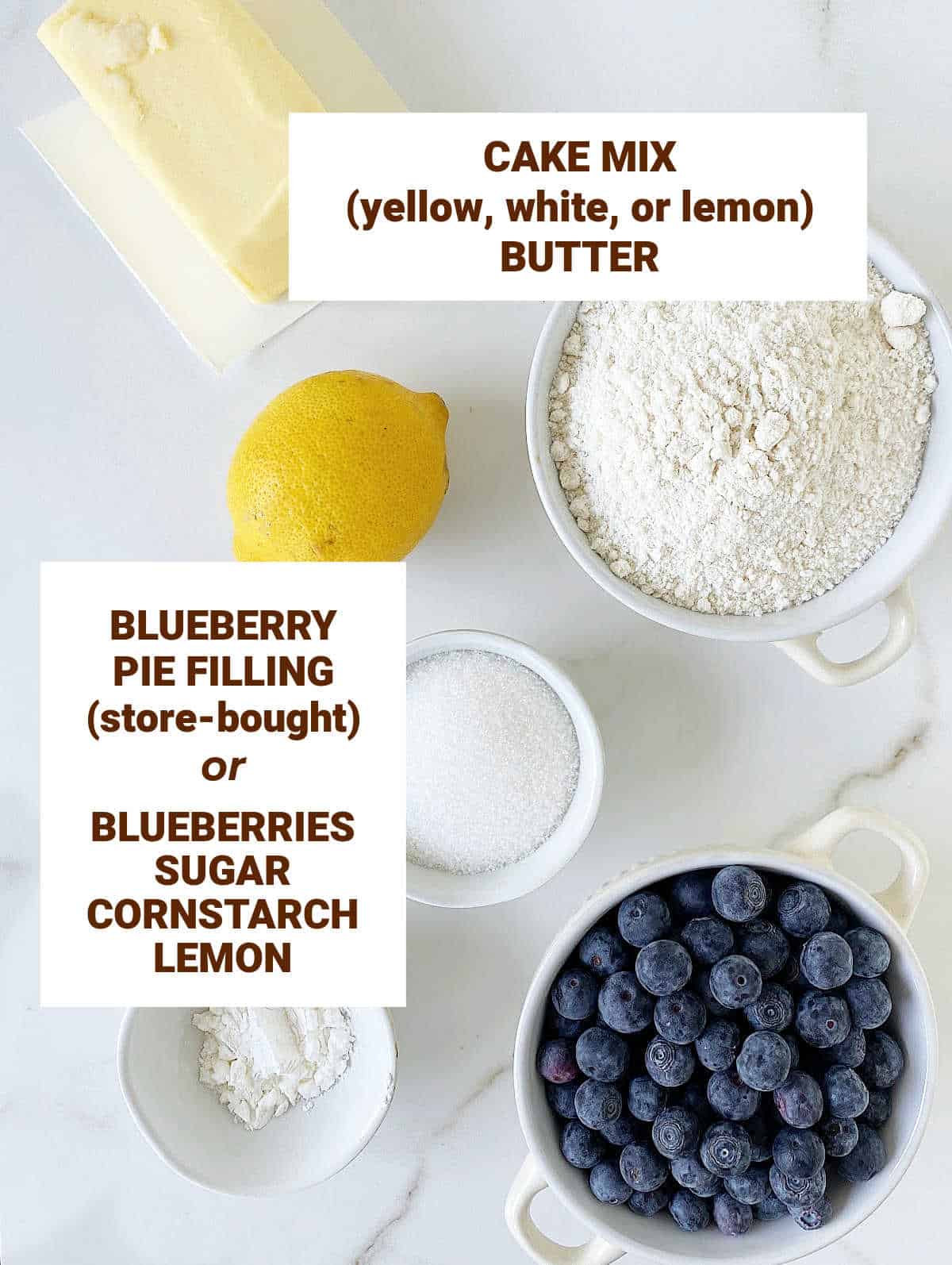 Bowls with ingredients for blueberry dessert including cake mix, lemon, sugar, butter. White surface; text overlay.