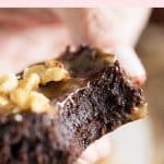 Close up of bitten fudgy brownie, pink brown text overlay