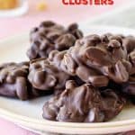Pink plate with chocolate peanut clusters on pink background, loose peanuts around; red text overlay