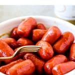 White bowl with fork and cocktail sausages; red text overlay