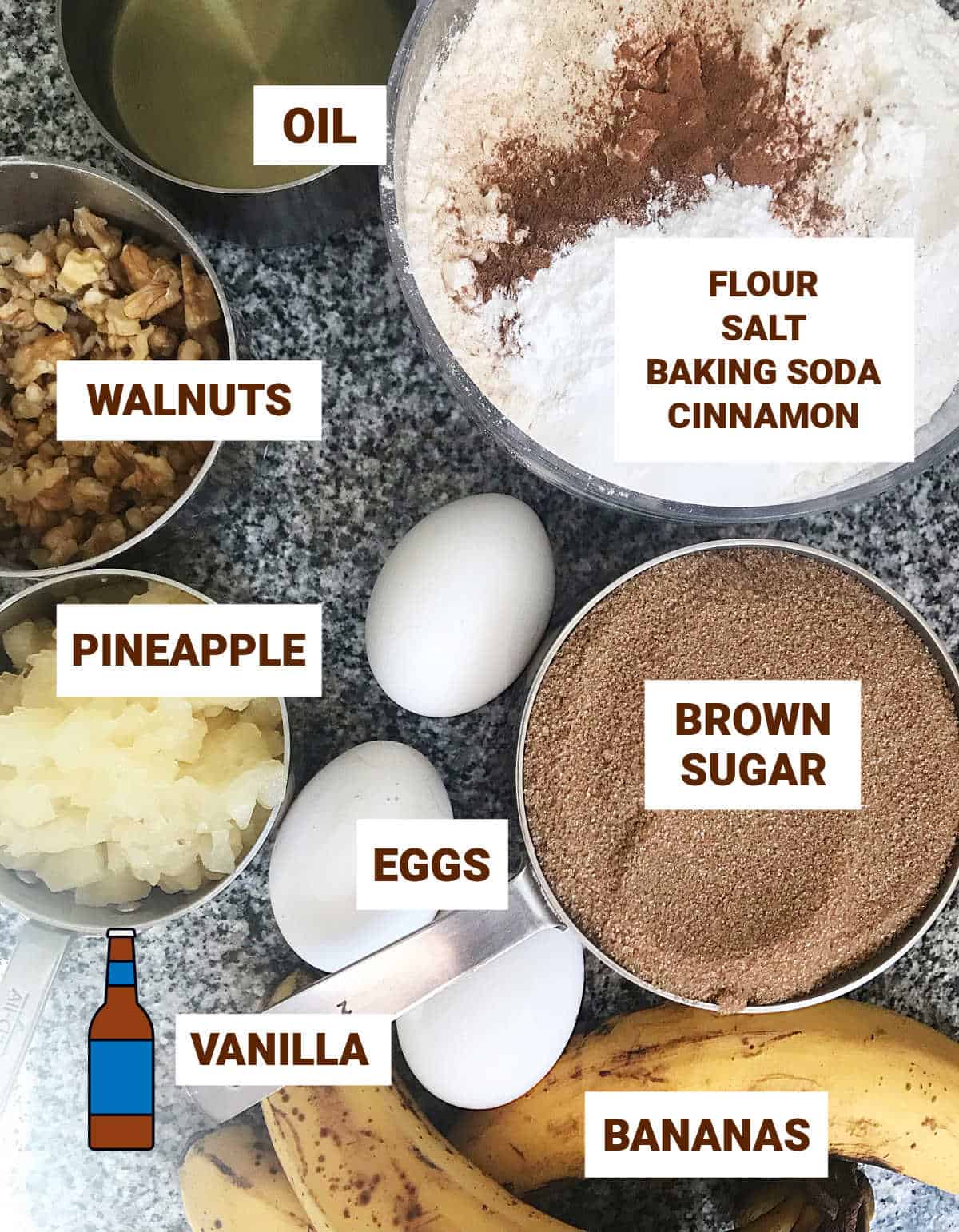 Banana pineapple cake ingredients in bowls on a grey surface including oil, eggs, brown sugar and walnuts.