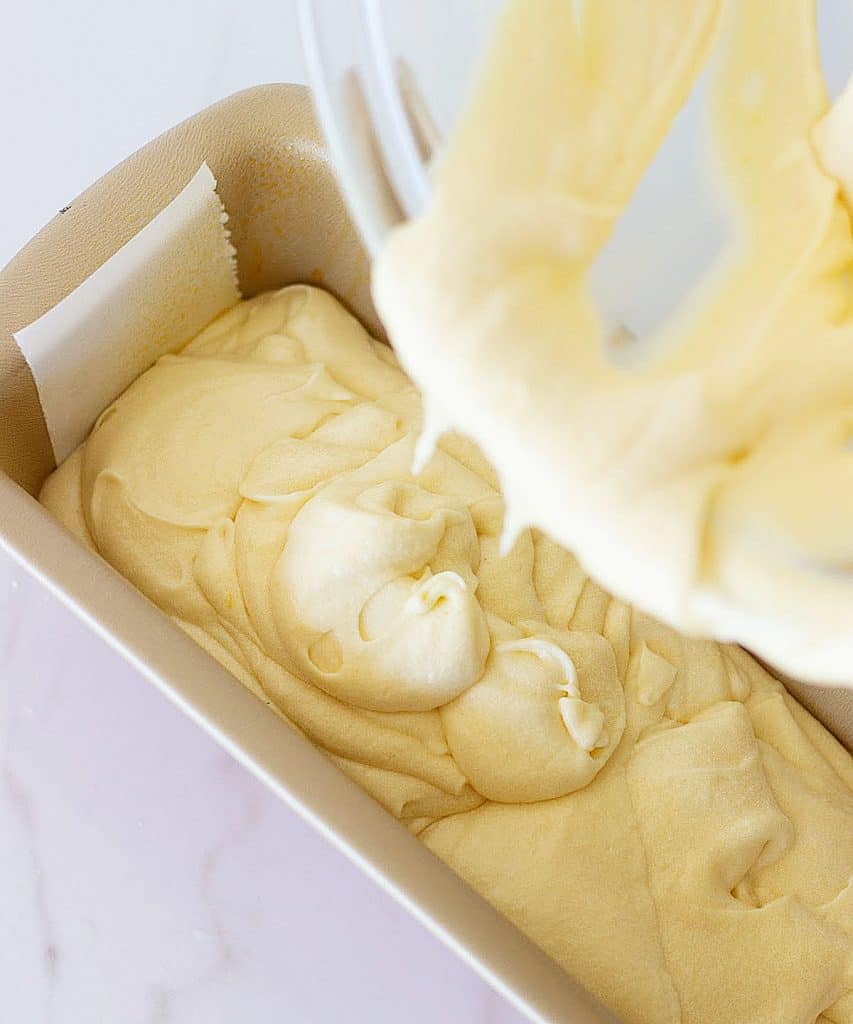 Pouring pound cake batter in a loaf pan