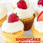 Several whole strawberry shortcake cupcakes on white plate; red text overlay