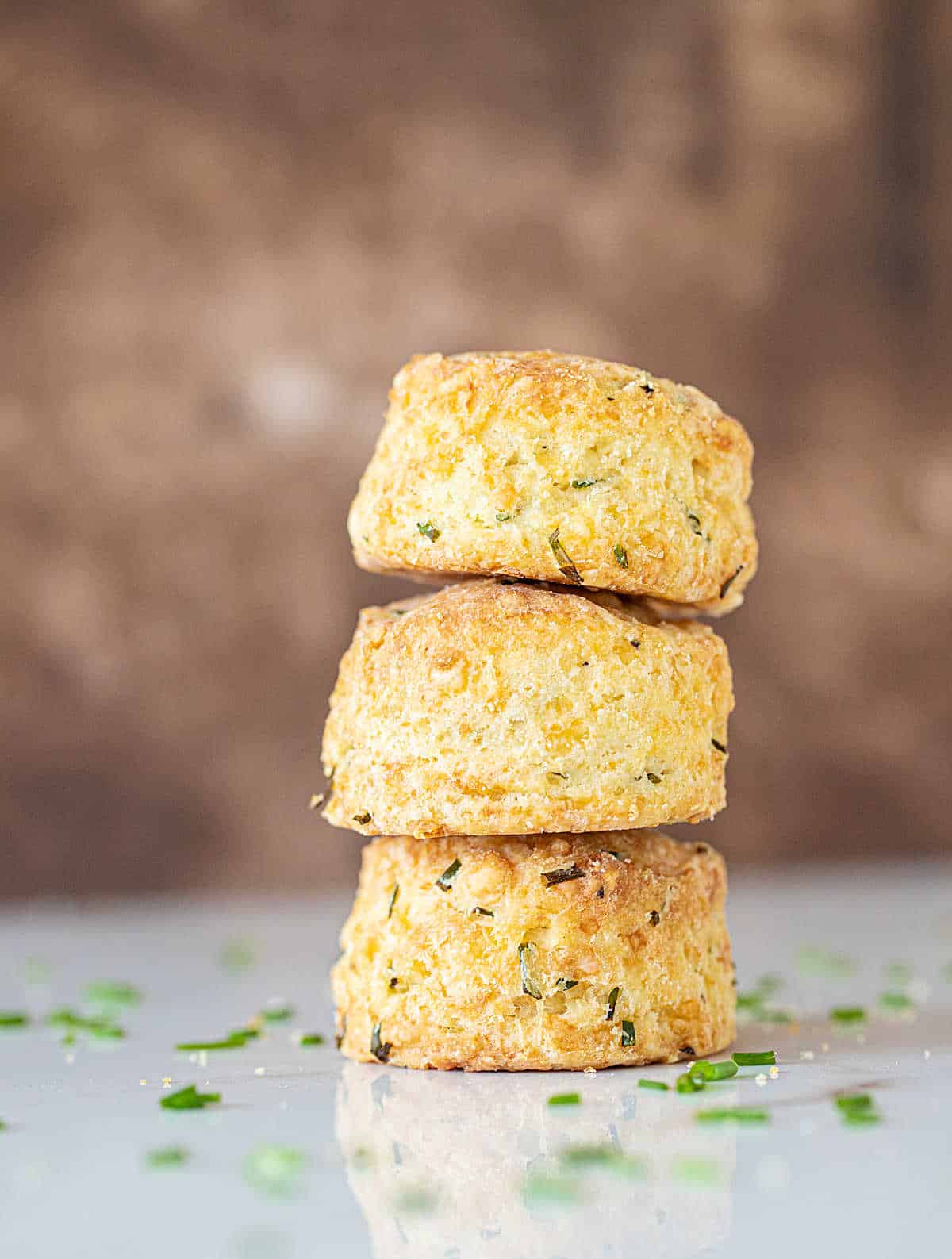 Three scones stacked with brown background