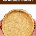 Round graham cracker pie crust on white surface, brown white text overlay