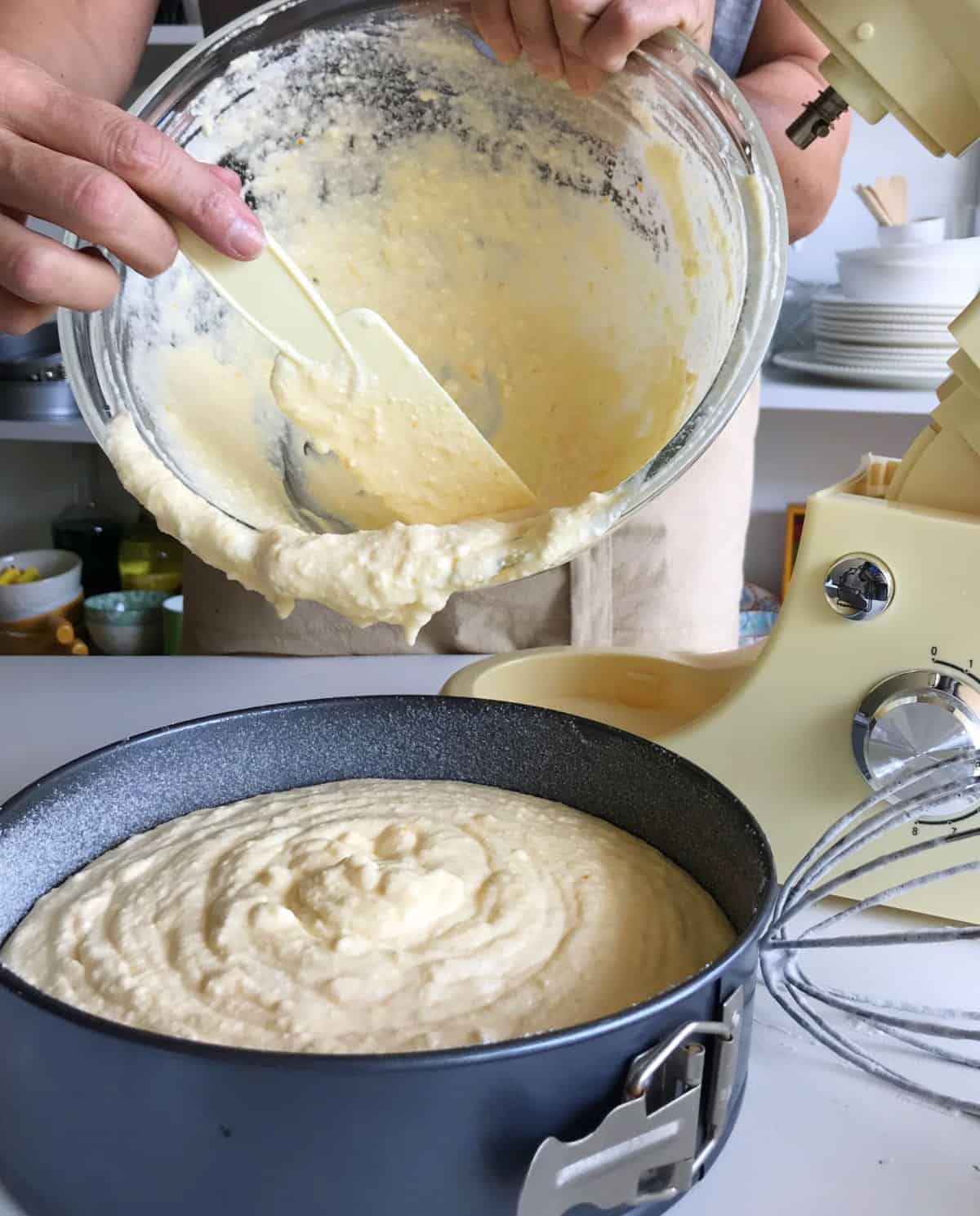 Pouring orange ricotta cheesecake mixture into the pan