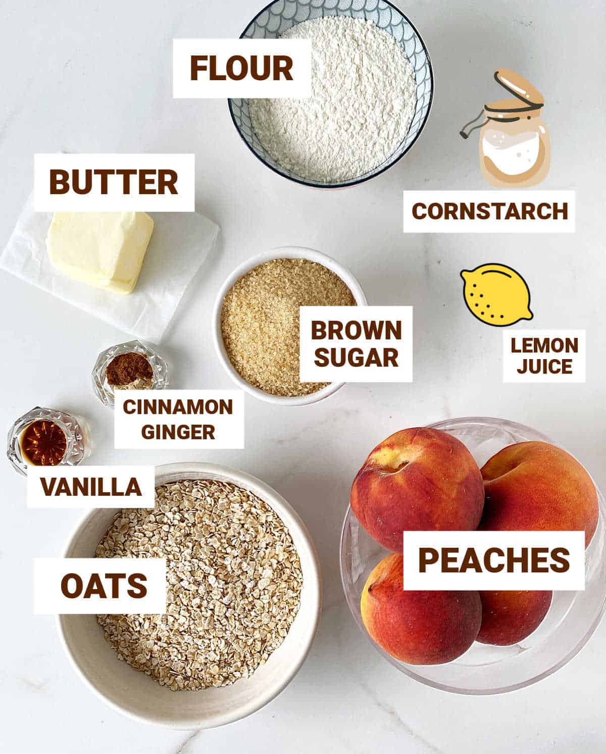 White surface with ingredients for peach crisp including oats, brown sugar, spices, lemon, butter. flour, vanilla.