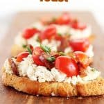 Several ricotta tomato toasts on wooden board, red text overlay