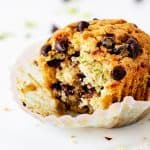 Close up of single bitten muffins with chocolate chips on white background