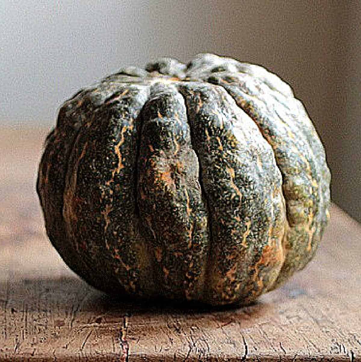 Whole green English Pumpkin on a wooden table