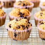 Several oatmeal chocolate chips muffins in paper liners on wire rack