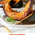 Roasted pumpkin wedges on white surface, brown background, herbs, fork, orange text overlay