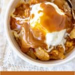 Caramel apple dump cake serving in white bowl with ice cream, white napkin, brown text overlay