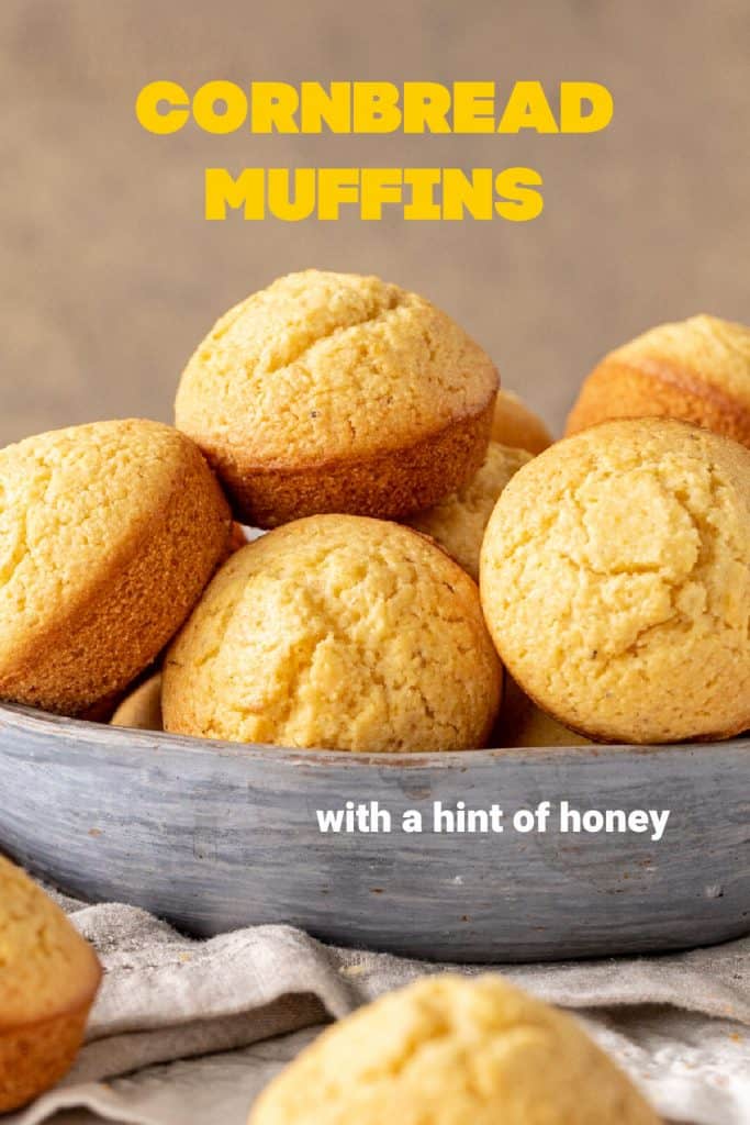 Bowl of cornbread muffins with beige background, yellow text overlay
