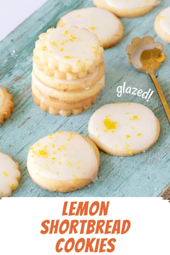 Orange and white text overlay on image of green wooden board with glazed lemon cookies.