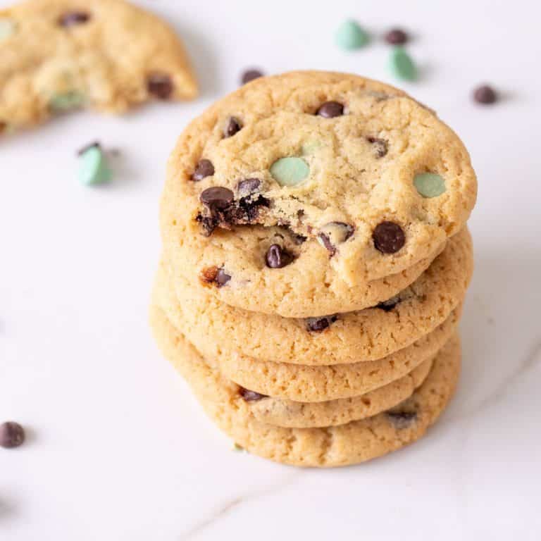 Close up of stack of chocolate mint cookies on white surface