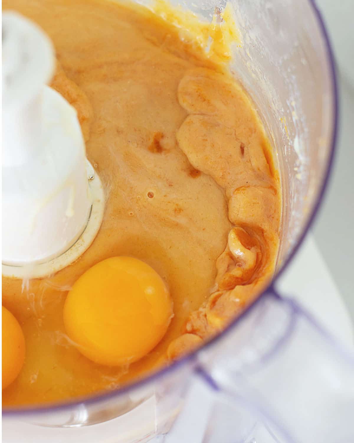Eggs and sweet potato mixture inside of a food processor bowl.