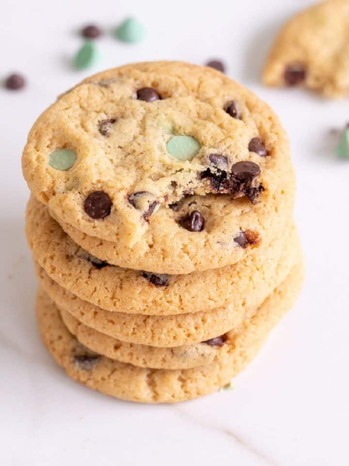 Close up of stack of chocolate mint cookies on white surface