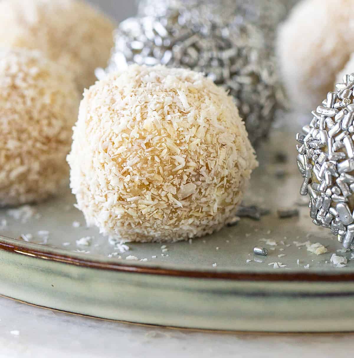 Blue grey plate with white coconut and silver sprinkle truffles