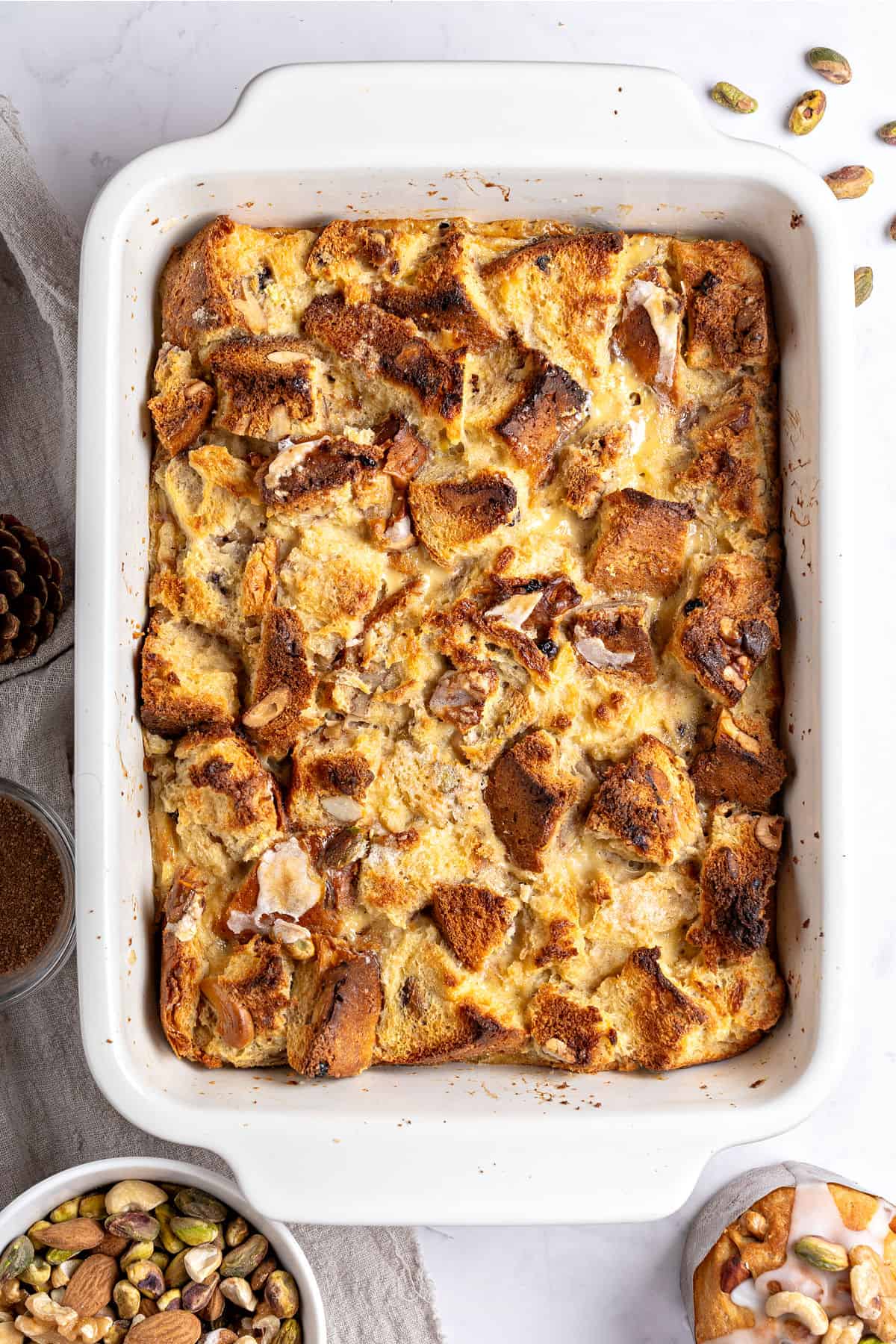 Top view of rectangular white dish with panettone bread pudding. Light gray surface.