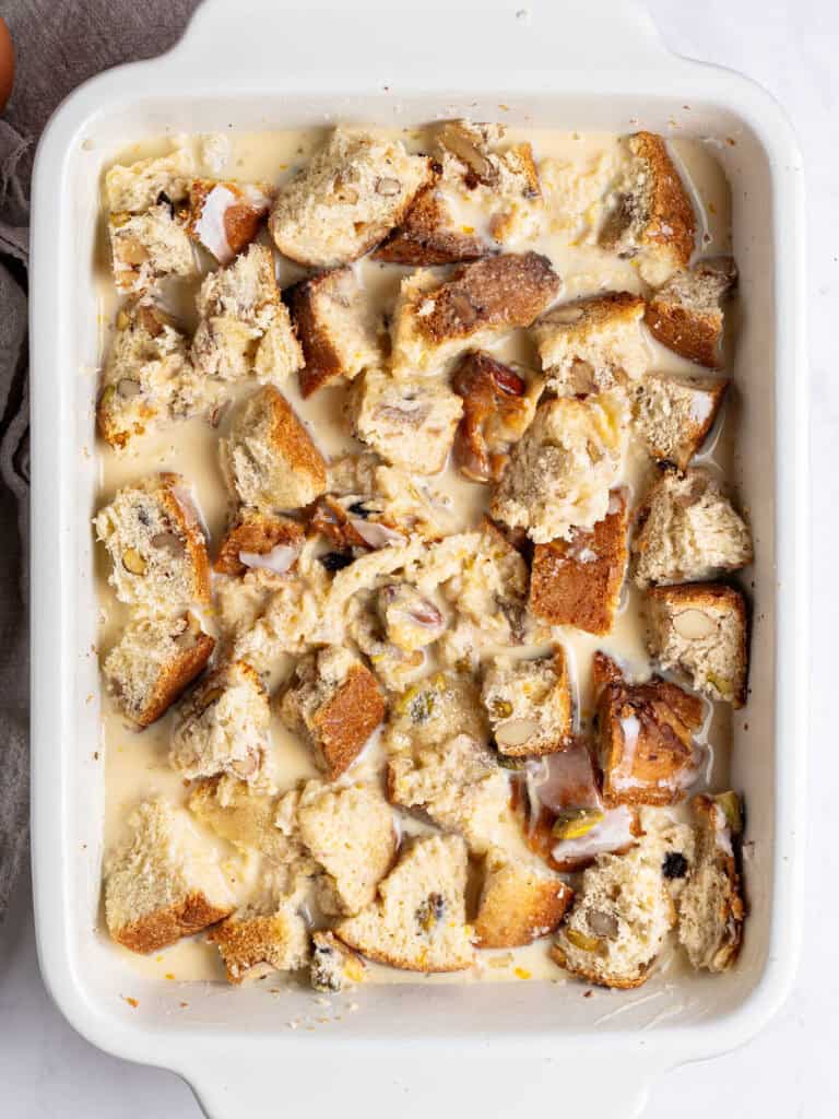 White rectangular baking dish with panettone bread pudding before baking. Top view.