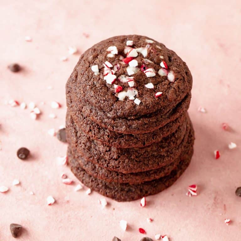 Close up of stack of chocolate peppermint cookies on pink surface