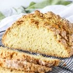 Wire rack with half Irish soda bread and slices.
