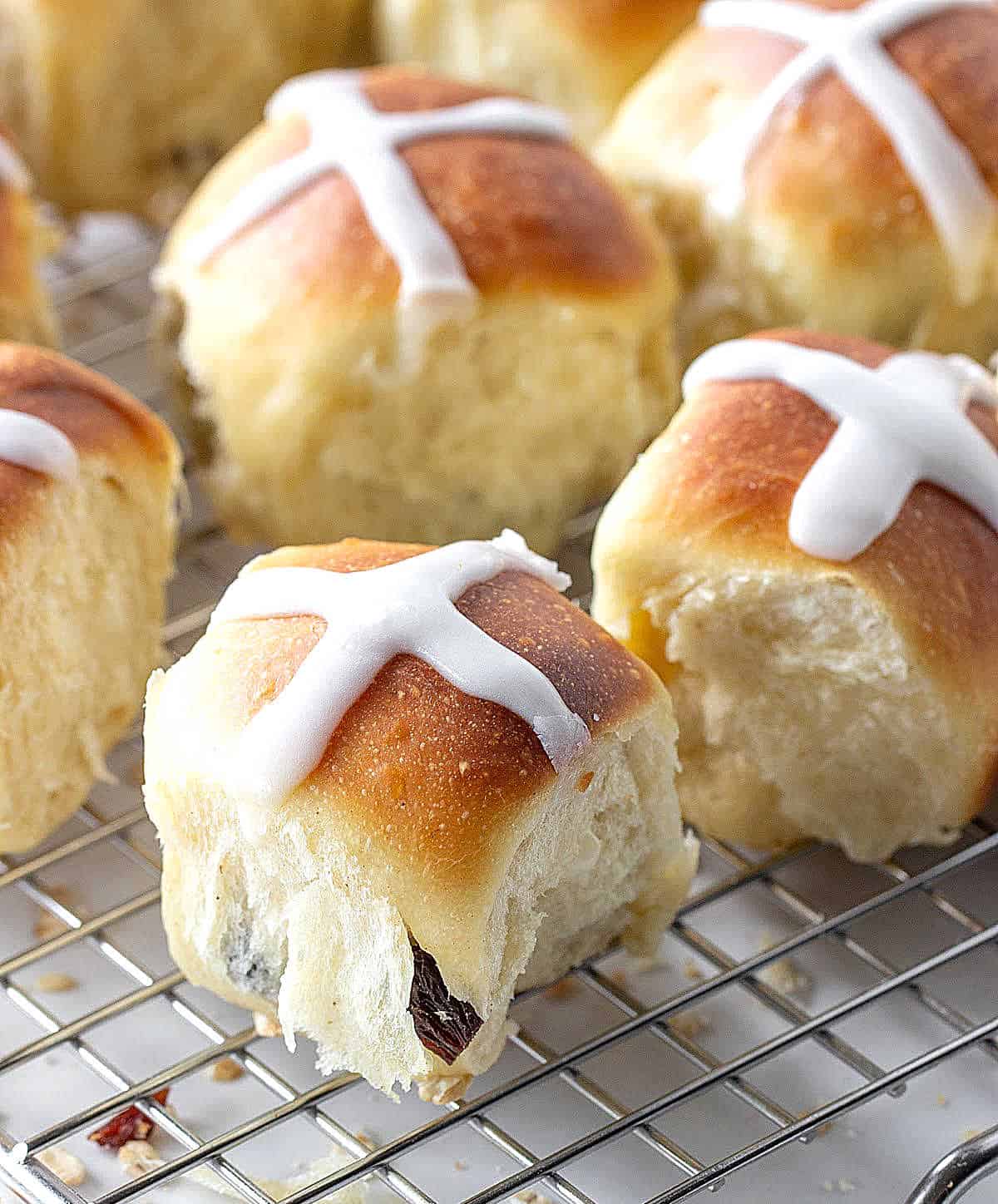 Close up of hot cross buns on a silver wire rack.