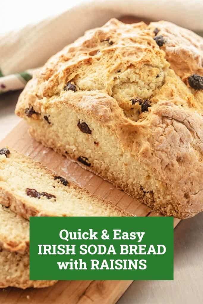 Loaf of Irish soda bread with raisins on wooden board, green text overlay.