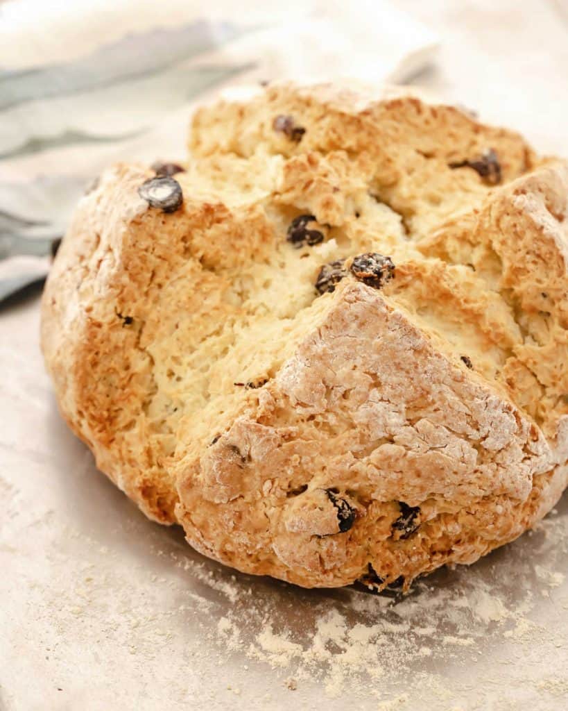 Raisin soda bread baked on a metal sheet.