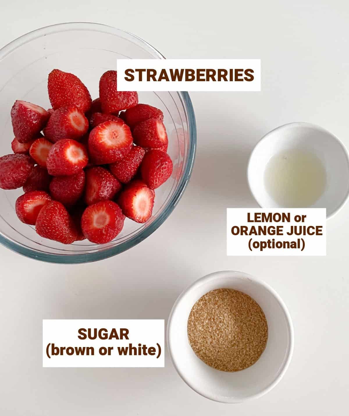 Bowls containing ingredients for strawberry compote on white surface, including lemon juice and brown sugar.